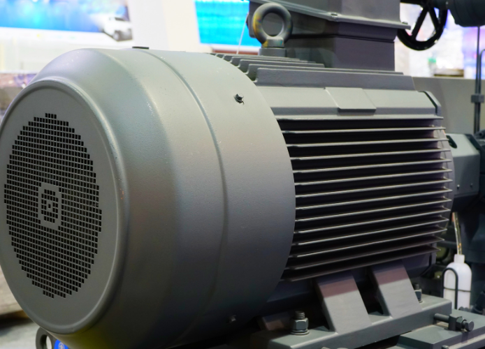 11Close-up view of an electric motor system with wiring, components, and industrial machinery parts.