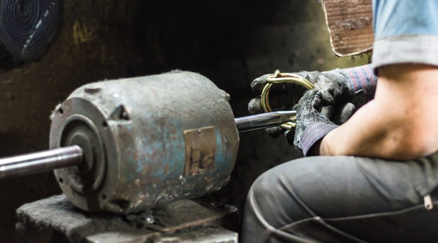 11Technician inspecting industrial machinery as part of Condition Based Monitoring and equipment maintenance.