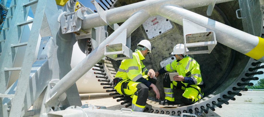 how-a-condition-monitoring-system-supports-predictive-maintenance 11Engineers inspecting industrial equipment as part of a condition monitoring system and predictive maintenance strategy.