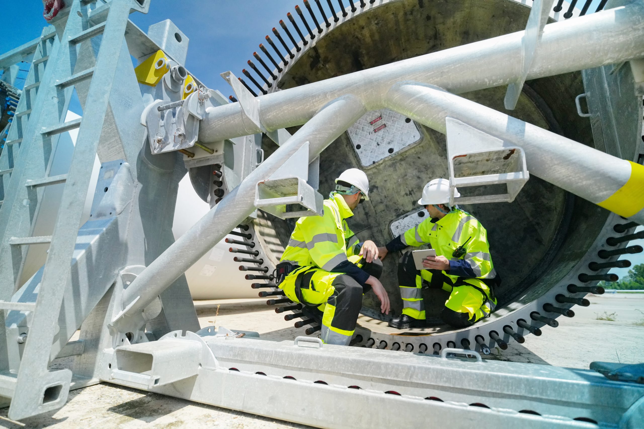 11Engineers inspecting industrial equipment as part of a condition monitoring system and predictive maintenance strategy.